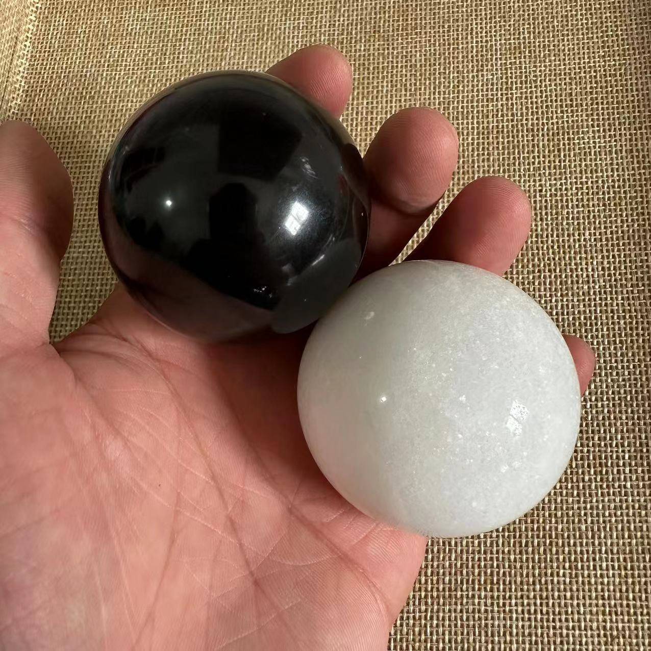 a pair of black stone with white jade, around 49mm